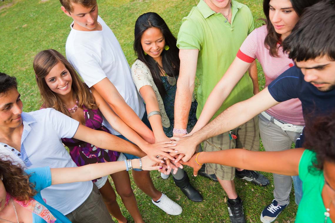 Group of teen fisting a boy